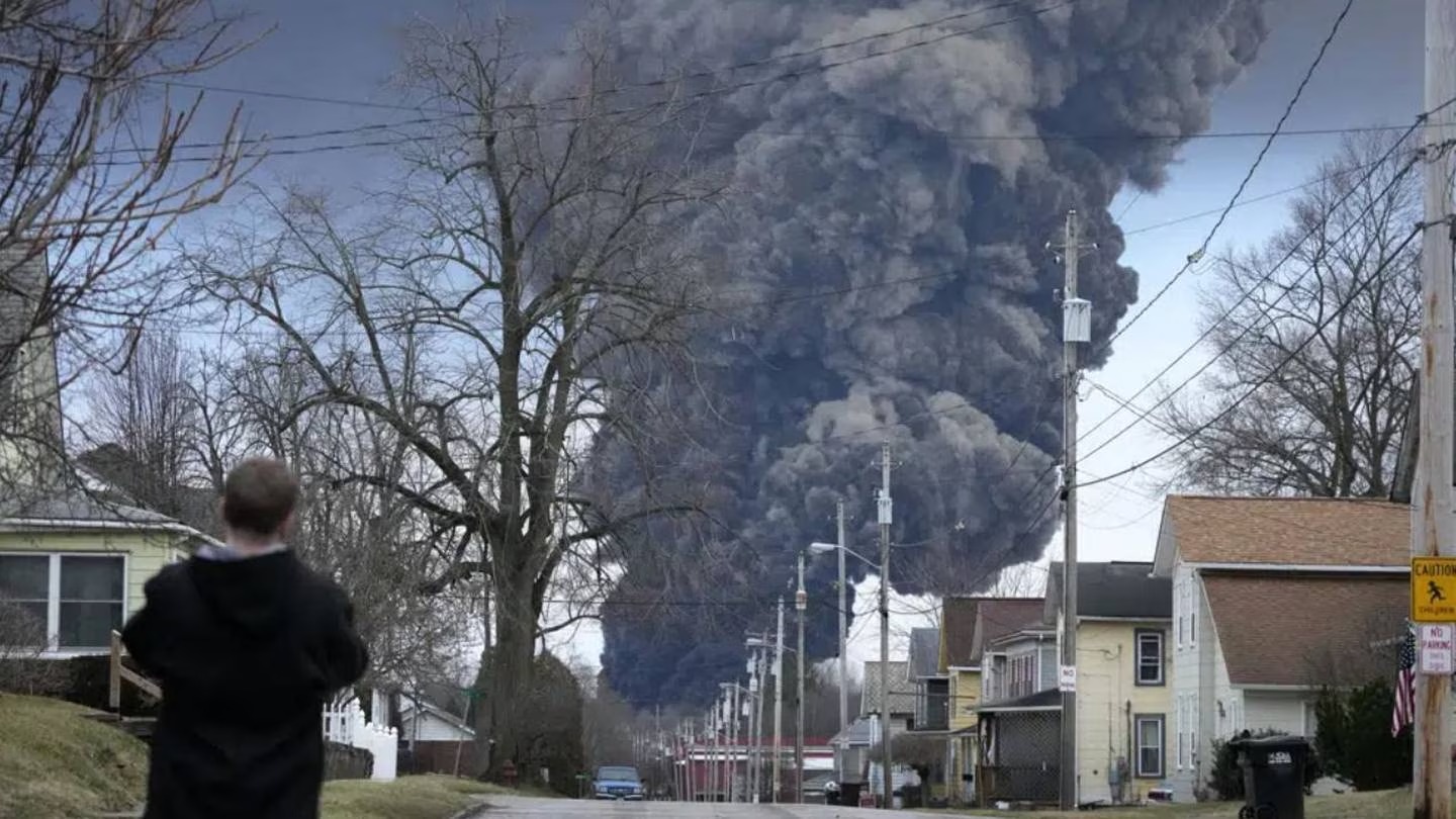 A black plume rises over East Palestine, Ohio, as a result of a controlled detonation of a portion of the derailed Norfolk Southern trains. Photo / AP