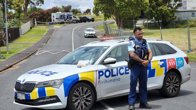 Police stand guard near the scene in a West Auckland reserve where a security guard was found dead on December 18. Photo / RNZ/Lucy Xia