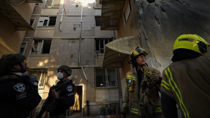 Israeli security forces inspect a damaged residential building after it was hit by a rocket fired from the Gaza Strip, in Sderot, Israel, Tuesday, Oct. 17, 2023. Photo / AP
