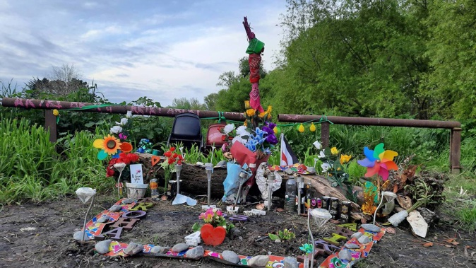 A scene tribute set up by family and friends of Ariki Rigby after she was found dead in the River Road Recreation Reserve near Havelock North a year ago.