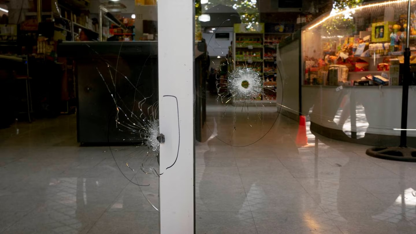 Bullets holes crack the Unico supermarket, a grocery chain owned by football player Lionel Messi's in-laws, in Rosario, Argentina. Photo / AP