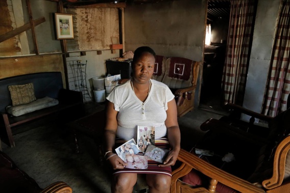 Mandy Sinanyoni with photographs of the Dickason family. (Photo / AP)