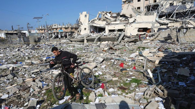 A Palestinian walks through the destruction by the Israeli bombardment in the Nusseirat refugee camp in Gaza Strip. Photo / AP