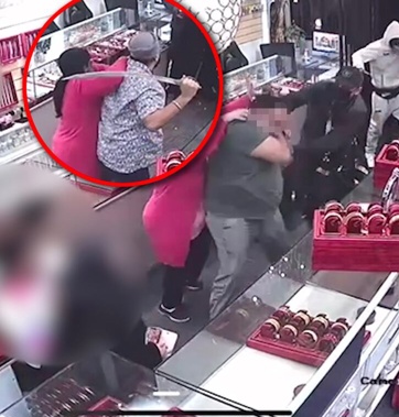 A jewellery store worker confronts armed robbers with a sword after they attacked the owner with a hammer today in Papatoetoe.