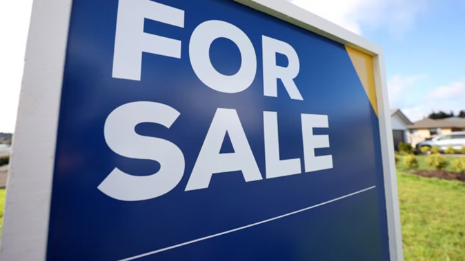 A for sale sign outside a house in Auckland. Fewer sales and lower prices this year have hit agents hard. Photo / Fiona Goodall