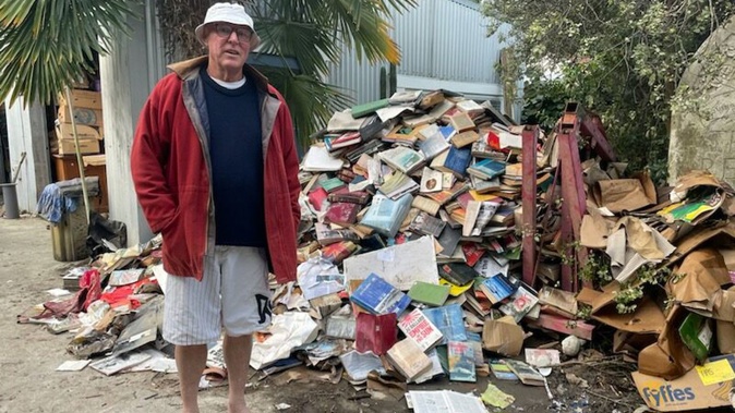 Dr David Guerin stands among years' worth of his material, all damaged in the flooding on Joll Road in Havelock North.