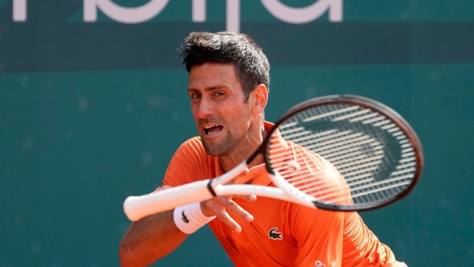 Novak Djokovic throws a racket during their final tennis match of the Serbia Open tennis tournament against Andrey Rublev of Russia. (Photo / AP)