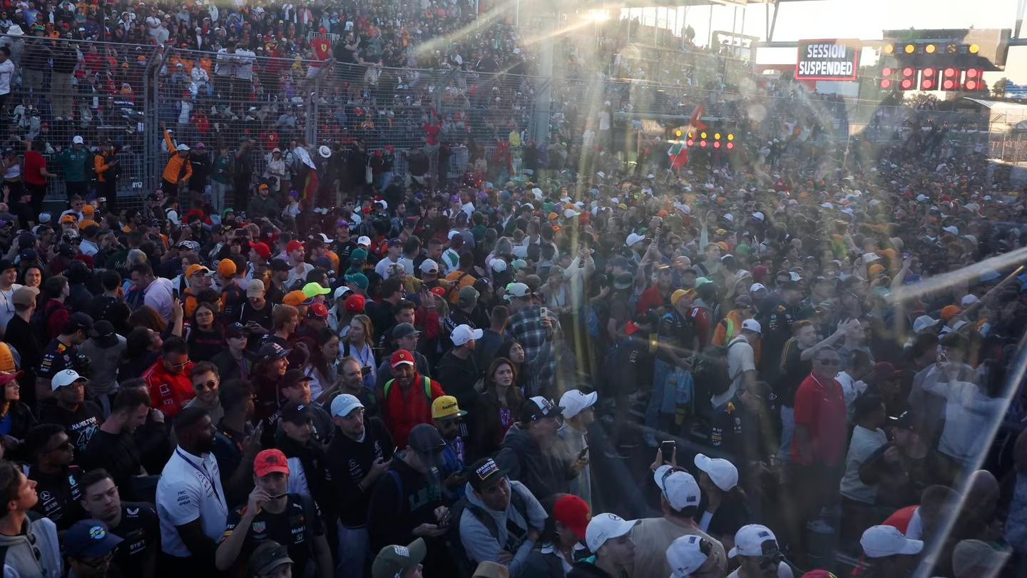 Fans flood onto the track after the finish of the Australian Formula One Grand Prix at Albert Park. Photo / AP