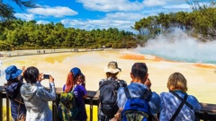 A group of people visiting the geothermal pools in Wai-O-Tapu Park. Photo / 123rf