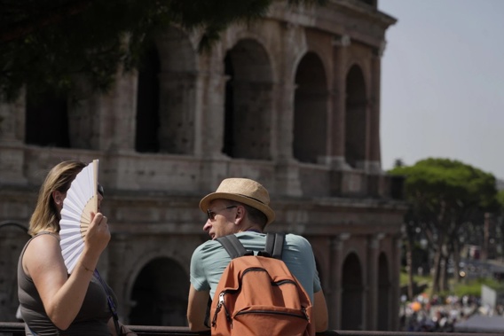 Tourists flock to the eternal city while scorching temperatures grip central Italy with Rome at the top of the red alert list as one of the hottest cities in the country. (AP Photo/Gregorio Borgia)
