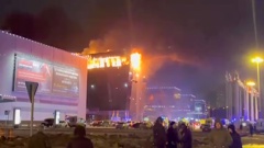 A screen grab from a video shows smoke rises from fire as ambulances, personnel arrive at Crocus City Hall concert venue near Moscow. Photo / AP