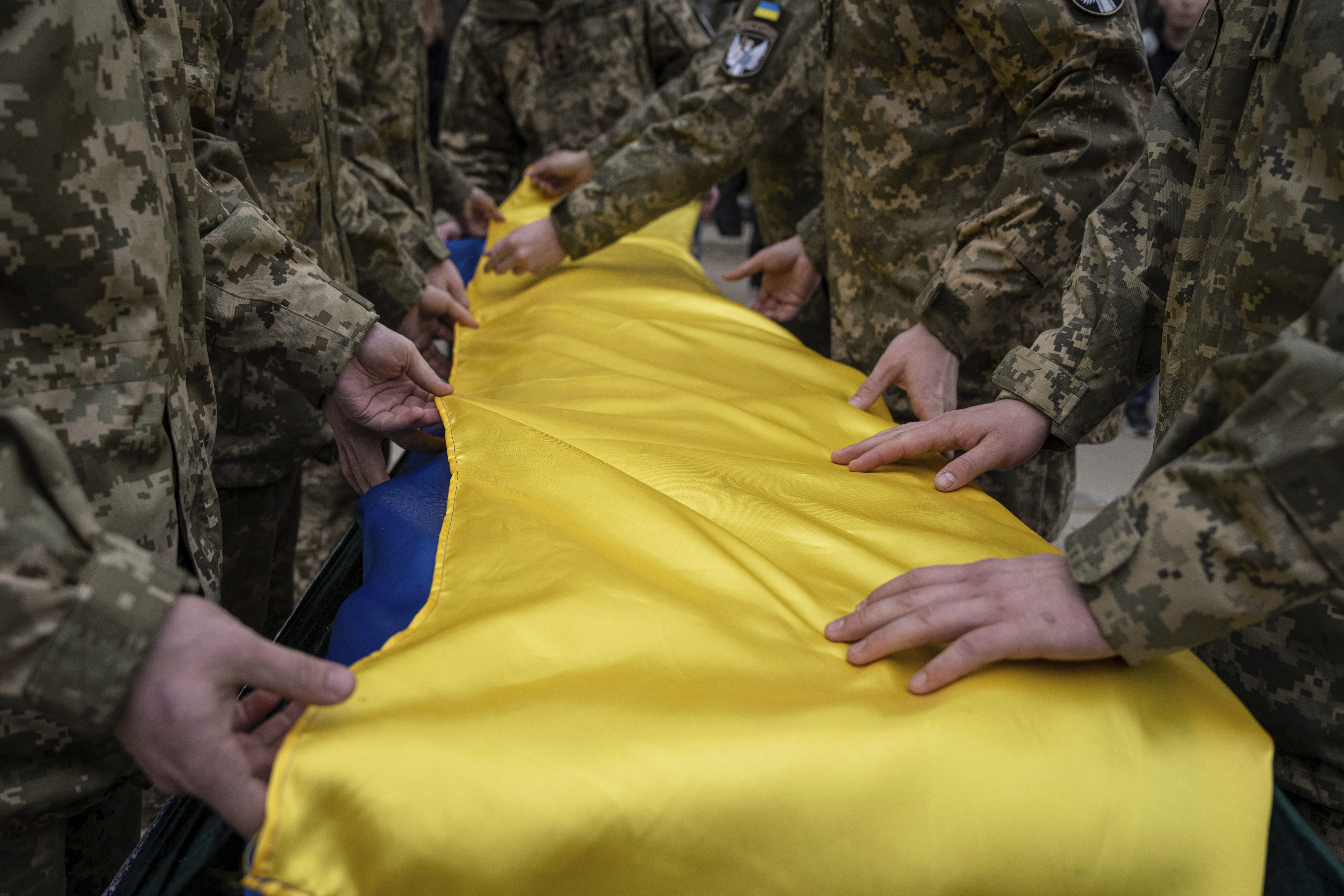 Ukrainian servicemen fold the national flag over the coffin of their comrade Andrii Neshodovskiy during the funeral ceremony in Kyiv, Ukraine, Saturday, March 25, 2023.  Photo / AP