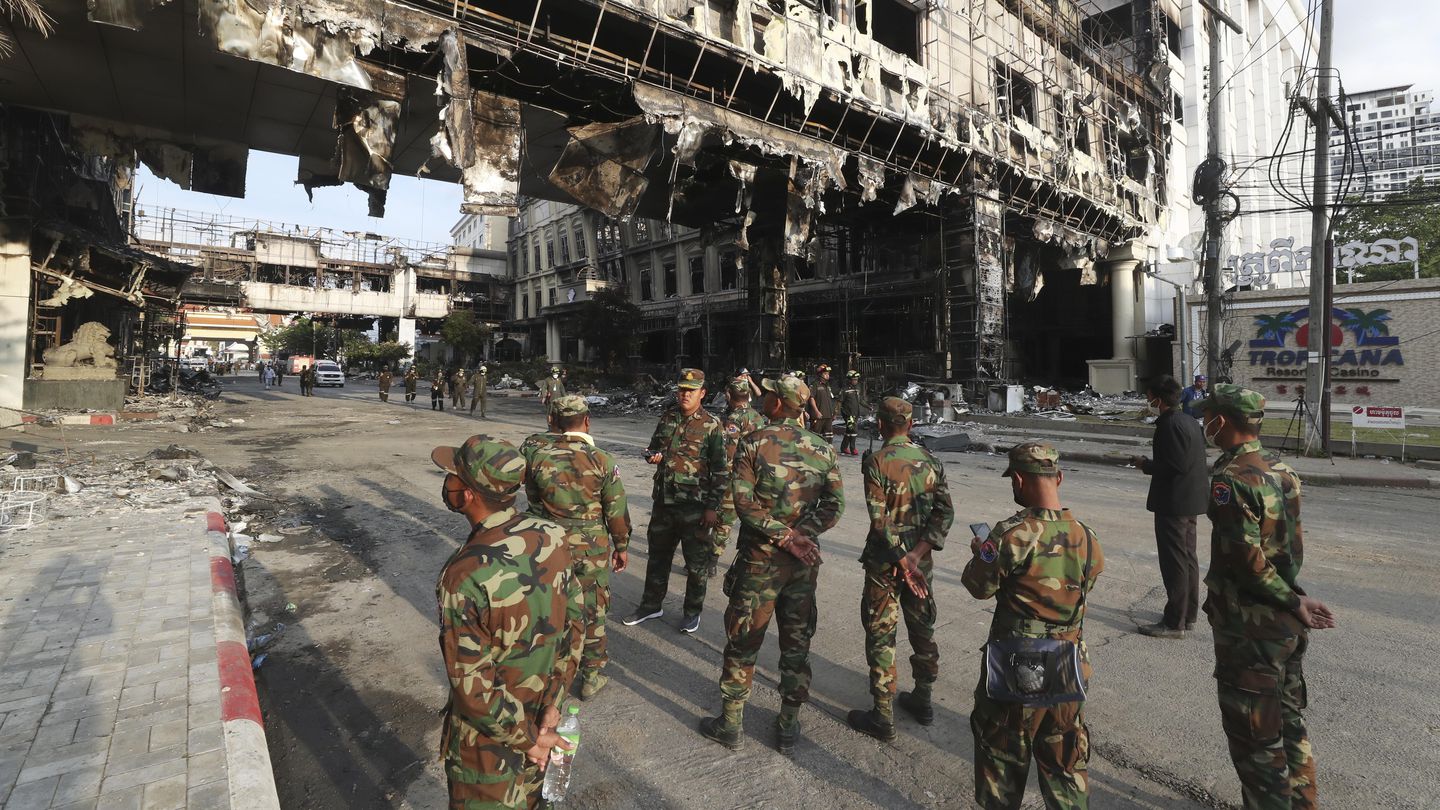 Cambodian military personnel stand guard near a ruined building at the scene of a massive fire at a Cambodian hotel casino in Poipet, west of Phnom Penh, Cambodia. Photo / AP
