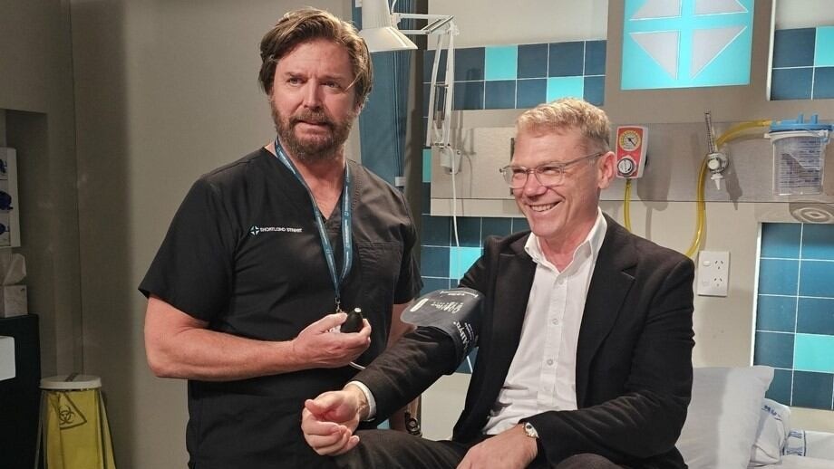 Shortland Street cast member Michael Galvin (Dr Chris Warner) checks Paul Goldsmith's blood pressure.