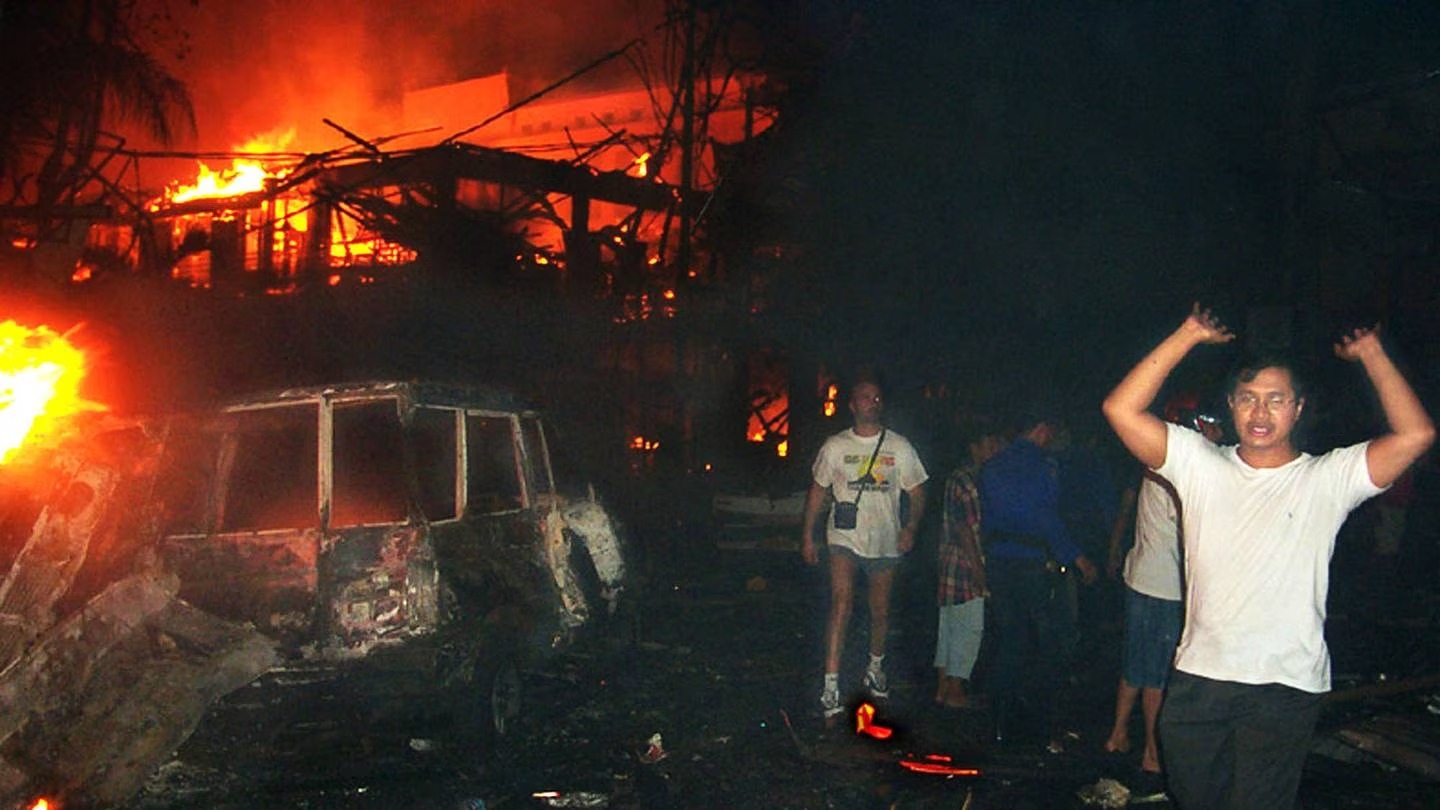 Residents and foreign tourists evacuate the scene of a bomb blast in Denpasar, Bali. Photo / AP
