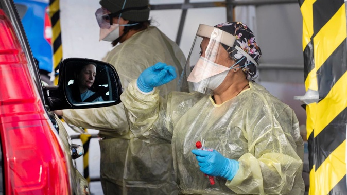 Staff in PPE at work in the Ora Toa Covid-19 Testing Centre in Cannon's Creek, Porirua, during lockdown. Photo / Mark Mitchell