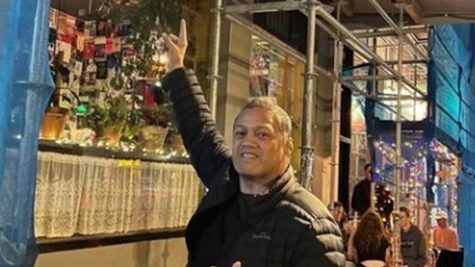 Destiny Church pastor Derek Tait posing outside of Woof! in Dunedin. (Photo / Supplied)