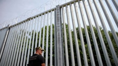 A Polish border guard patrols the area of a newly built metal wall on the border between Poland and Belarus. Photo / AP