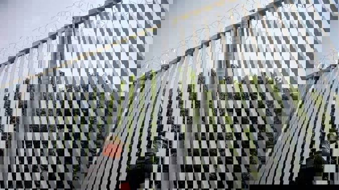A Polish border guard patrols the area of a newly built metal wall on the border between Poland and Belarus. Photo / AP
