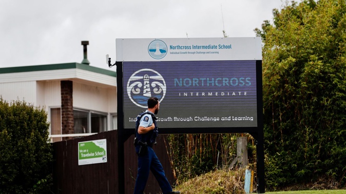Police at the Northcross Intermediate School in Browns Bay after the school went into lockdown following a threatening phone call. Photo / Dean Purcell