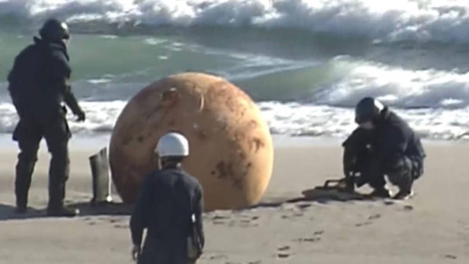 A large round object has been washed up on a Japanese beach. Photo / Twitter / @PopMovieTv