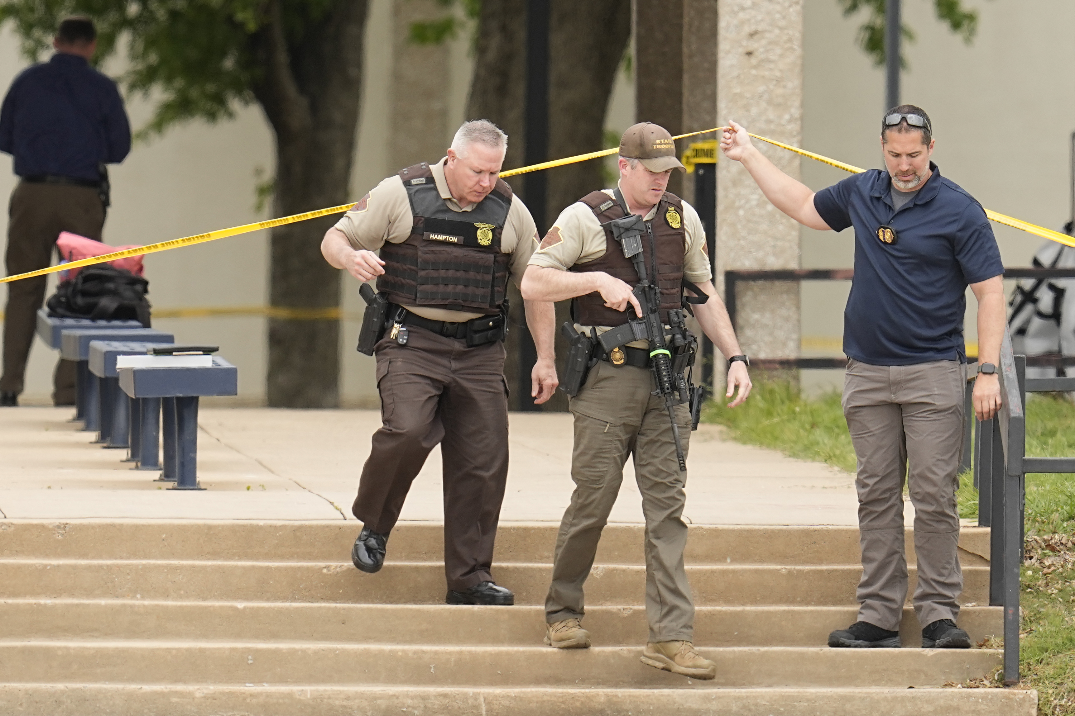 Oklahoma state troopers walk under police tape following a fatal shooting at Rose State College in Midwest City, Okla., on Monday, April 24, 2023. Police said a suspect is in custody after school officials told students to shelter in place. Photo / AP