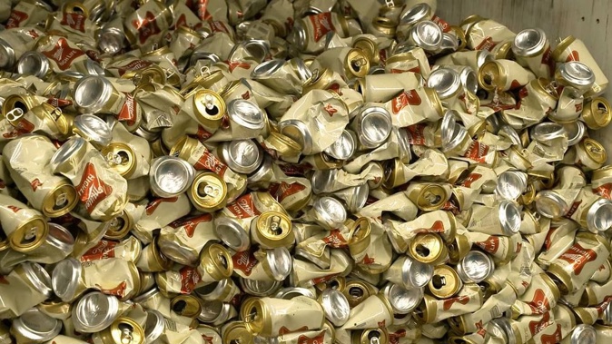Cans of Miller High Life beer sit in a container after being crushed at the Westlandia plant in Ypres, Belgium. Photo / AP