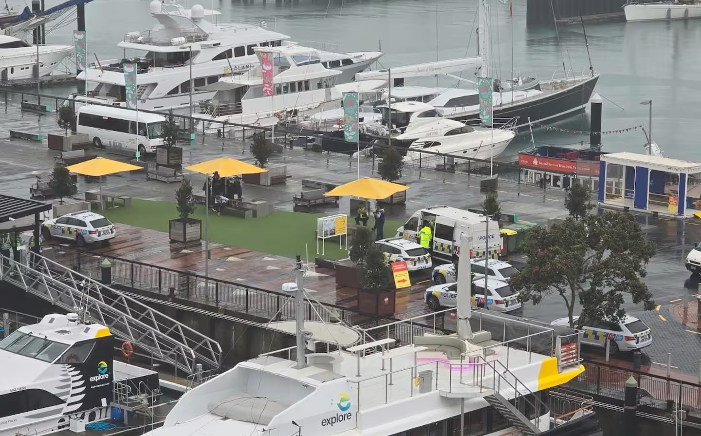 Police were seen waiting for a boat to dock at Auckland's Eastern Viaduct before arresting several men when they disembarked early Saturday evening.