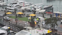 Police were seen waiting for a boat to dock at Auckland's Eastern Viaduct before arresting several men when they disembarked early Saturday evening.