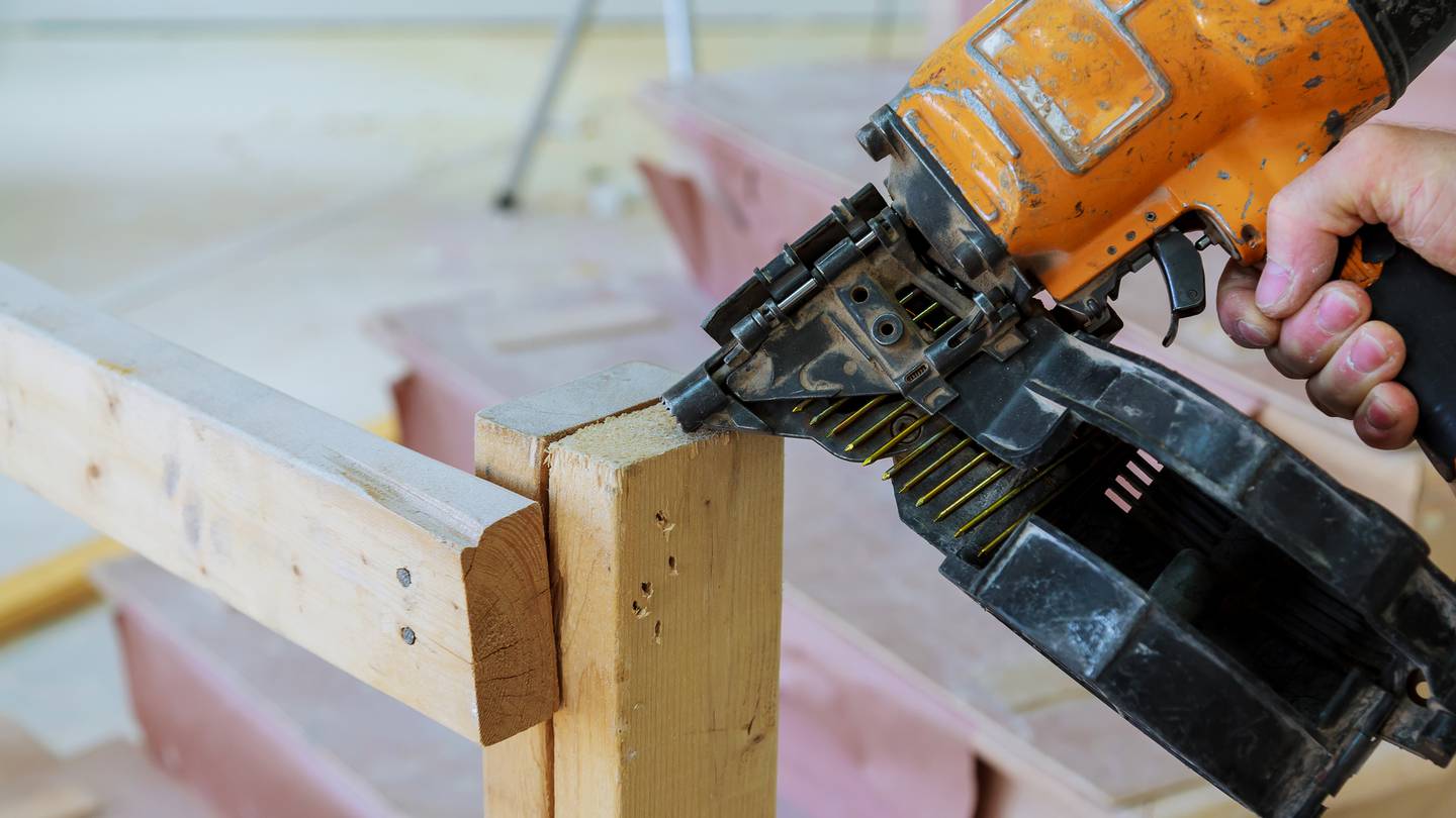 Buying two nail guns would have sent an apprentice into debt. Photo / 123rf