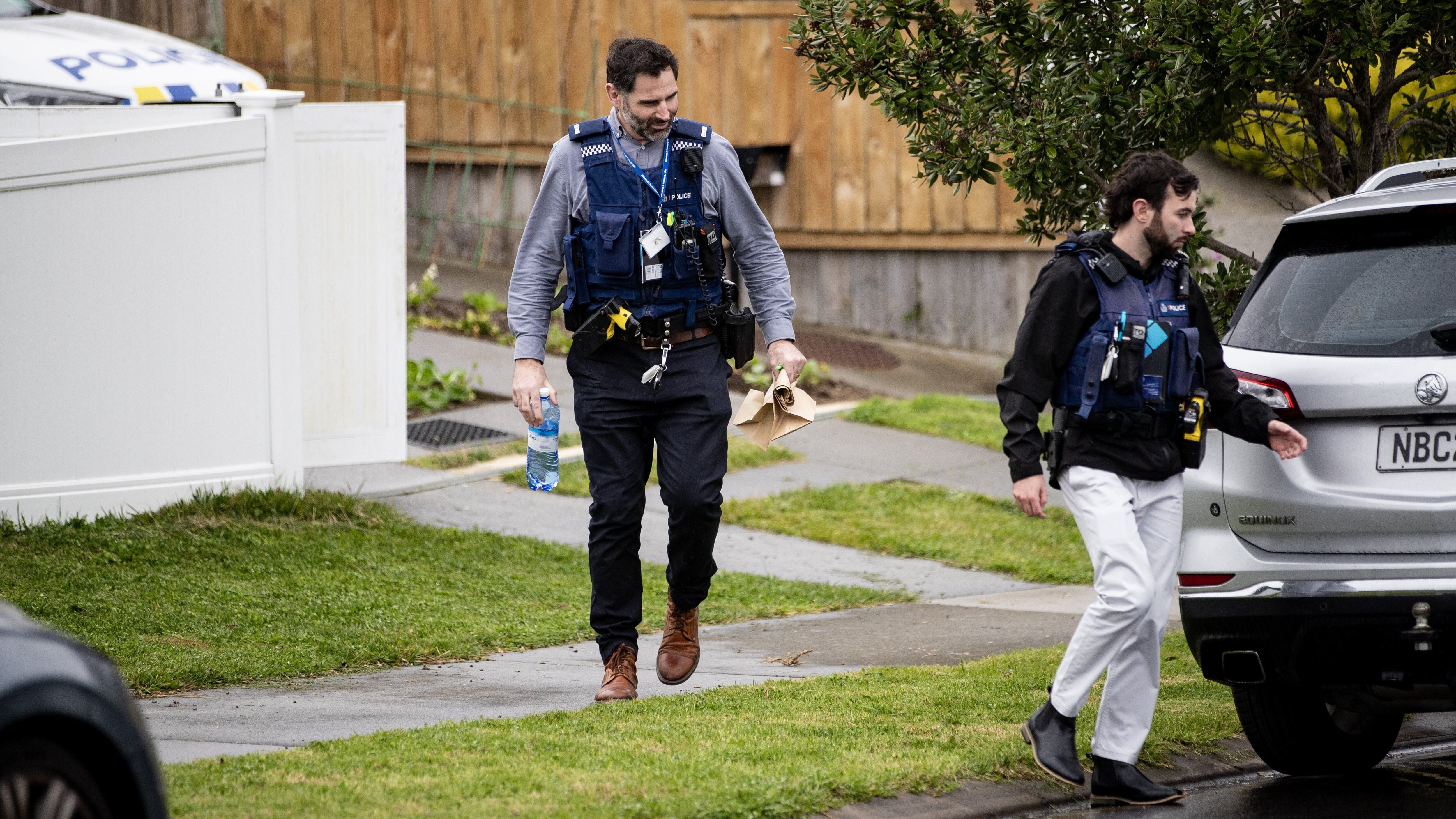 Detectives at the home in Orewa's Harvest Ave on Monday undertaking a scene examination. Police would remain there for several days. Photo / Dean Purcell