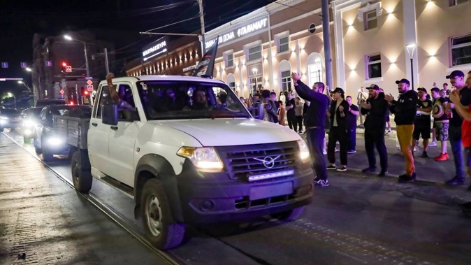 Local people applaud servicemen of the Wagner Group military company. Photo / AP