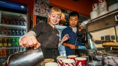 Barista Jessa Mitchell (left) with Sutto owner Jay Wang (right) making $2 coffee to celebrate the cafe's 15th anniversary. Photo / Paul Taylor