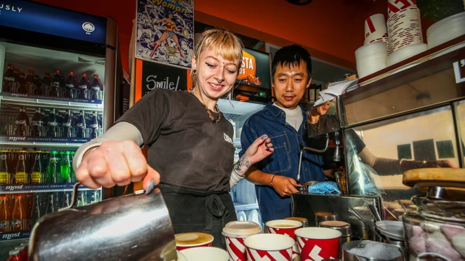 Barista Jessa Mitchell (left) with Sutto owner Jay Wang (right) making $2 coffee to celebrate the cafe's 15th anniversary. Photo / Paul Taylor