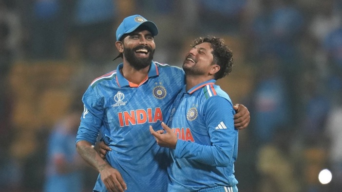 India's Kuldeep Yadav, right, and Ravindra Jadeja celebrate the dismissal of Netherlands' Logan Van Beek. (Photo / AP)