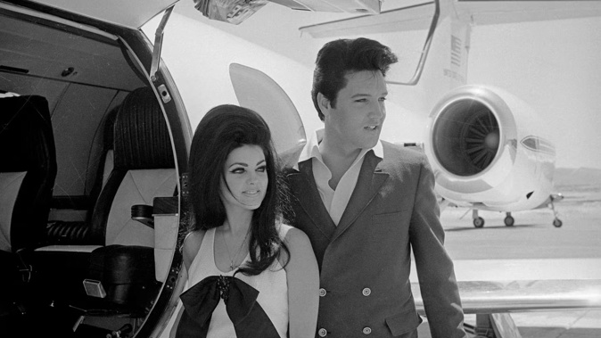 Newlyweds Elvis and Priscilla Presley, who met while Elvis was in the Army, prepare to board their private jet following their wedding. Photo / Getty