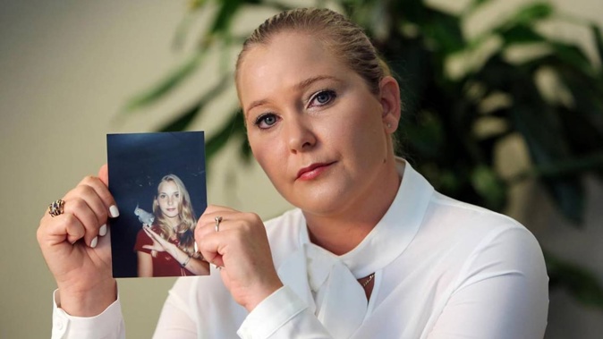 Virginia Giuffre, with a photo of herself as a teen, when she says she was abused by Jeffrey Epstein, Ghislaine Maxwell and Prince Andrew, among others. Photo / Getty Images