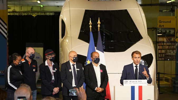 French President Emmanuel Macron speaks in front of a life-size replica of the next high-speed train, TGV, in Paris. (Photo / AP)