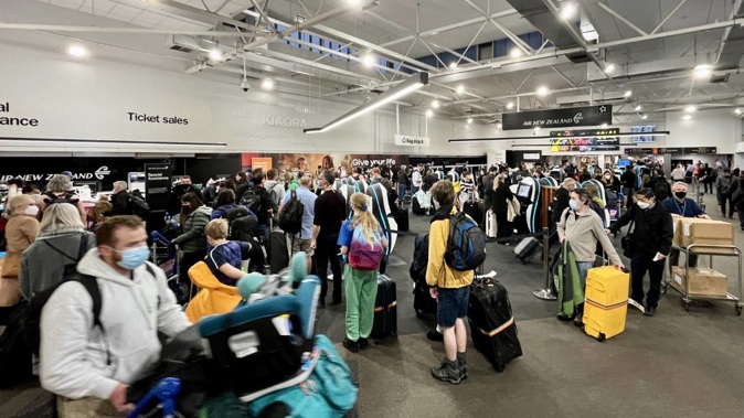 Chaotic scenes at Auckland Airport as crowds of people check-in for flights as school holidays begin. Photo / Supplied