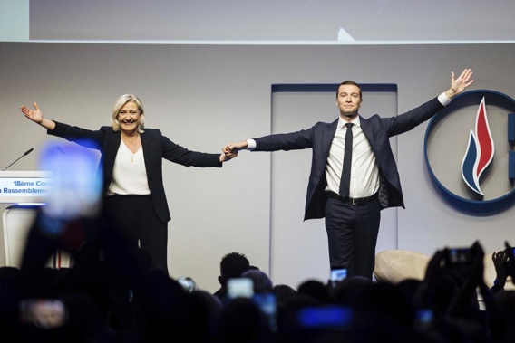 French far right leader Marine Le Pen celebrates with newly elected leader of the National Rally president Jordan Bardella during the party congress in Paris, Saturday, Nov. 5, 2022. Jordan Bardella is the first party chief outside the Le Pen family in a half-century. (AP Photo/Lewis Joly)