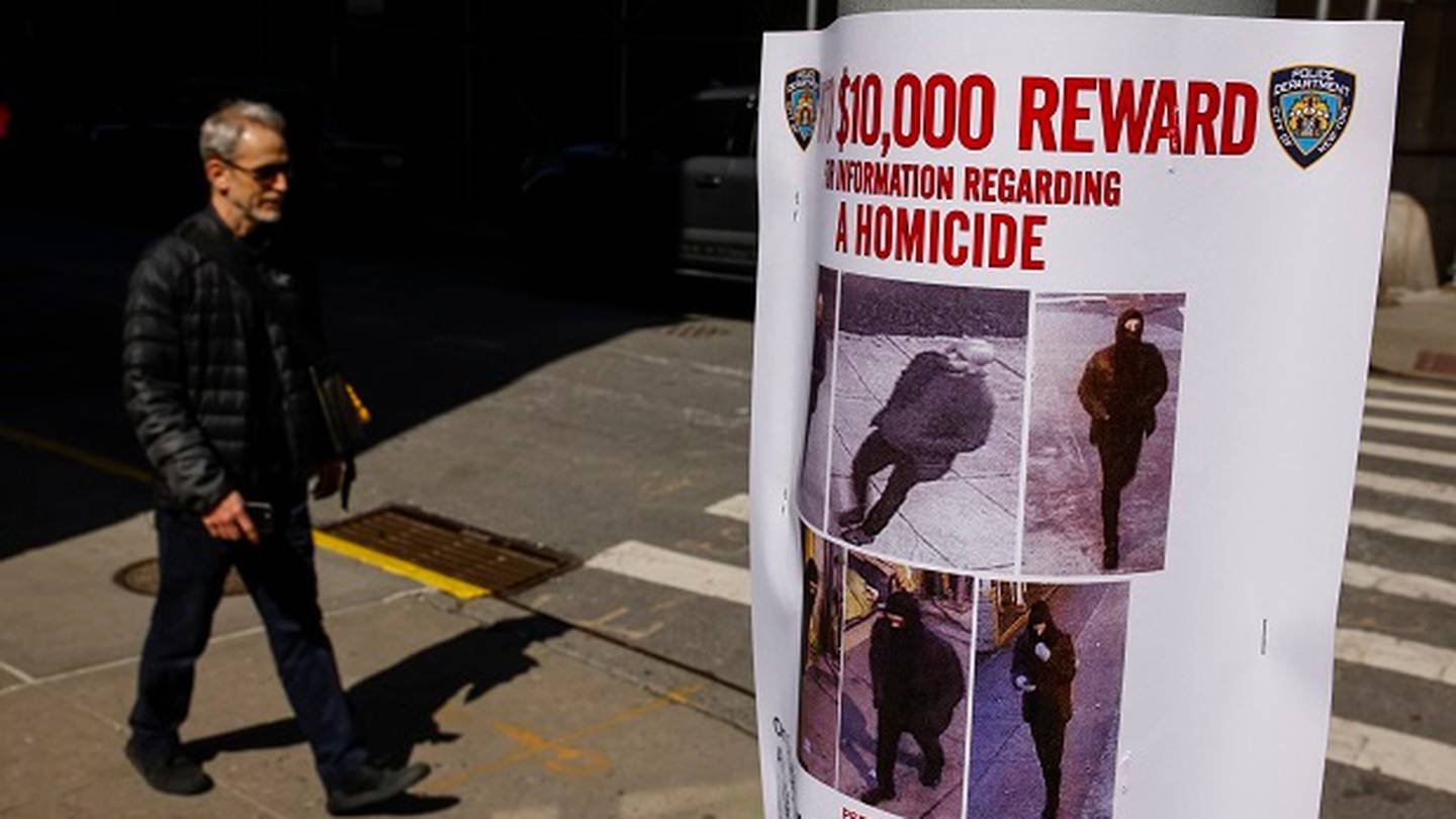 A pedestrian walks past a bulletin posted by NYPD near the place where a homeless person was killed. (Photo / AP)