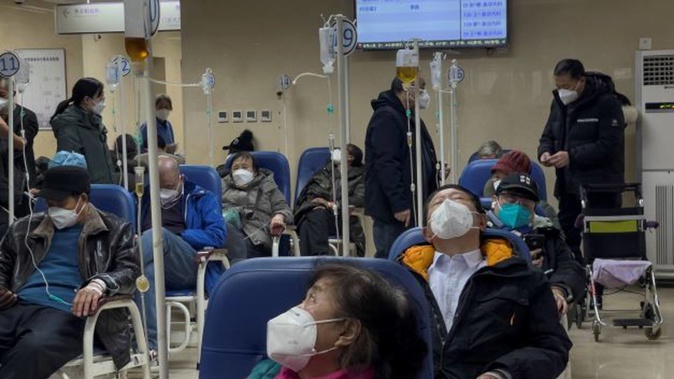 Patients receive intravenous drips at the emergency ward of a hospital in Beijing on Thursday. Patients, most of them elderly, are lying on stretchers in hallways and taking oxygen while sitting in wheelchairs as Covid-19 surges in China's capital. Photo / AP