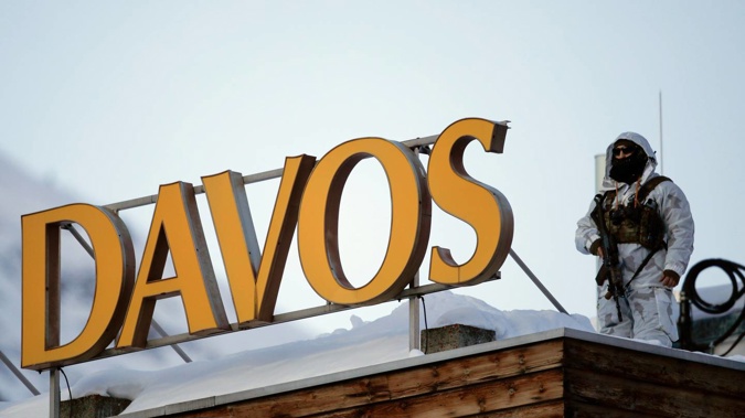 A police security guard on the roof of a hotel ahead of the World Economic Forum in Davos, Switzerland. Photo / AP