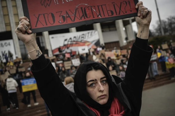 A woman holds a sign during a protest in Kyiv, Ukraine, Sunday March 24, 2024, to demand the freedom of Ukrainian Mariupol’s Azovstal defenders still being held prisoners by Russia. (AP Photo/Enric Marti)