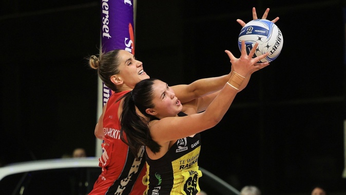 Te Paea Selby-Rickit of the Tactix (left) competes for the ball against Parris Mason of the Pulse. Photo / Photosport