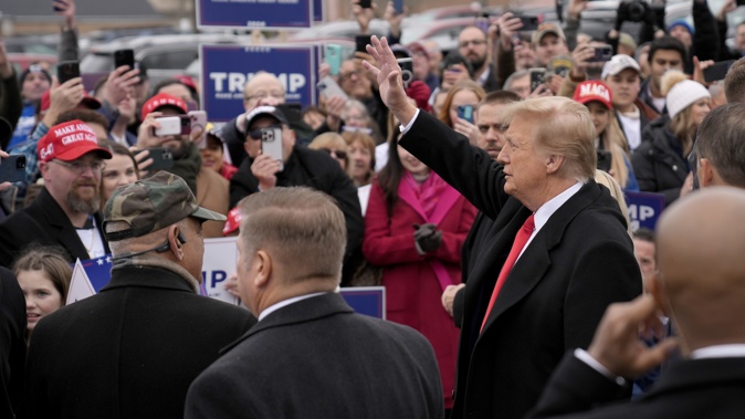 Republican presidential candidate former President Donald Trump waves to supporters as he arrives at a campaign stop in Londonderry, N.H. Photo / AP