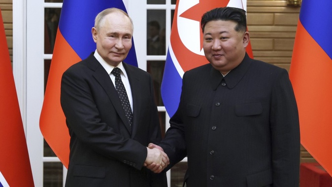 Russian President Vladimir Putin, left, and North Korea's leader Kim Jong Un shake hands while posing for a photo prior to their talks in Pyongyang, North Korea, Wednesday, June 19, 2024. (Gavriil Grigorov, Sputnik, Kremlin Pool Photo via AP)