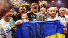 Oleksandr Usyk celebrates with his team after beating Tyson Fury in their clash for the undisputed heavyweight championship. Photo / Getty Images