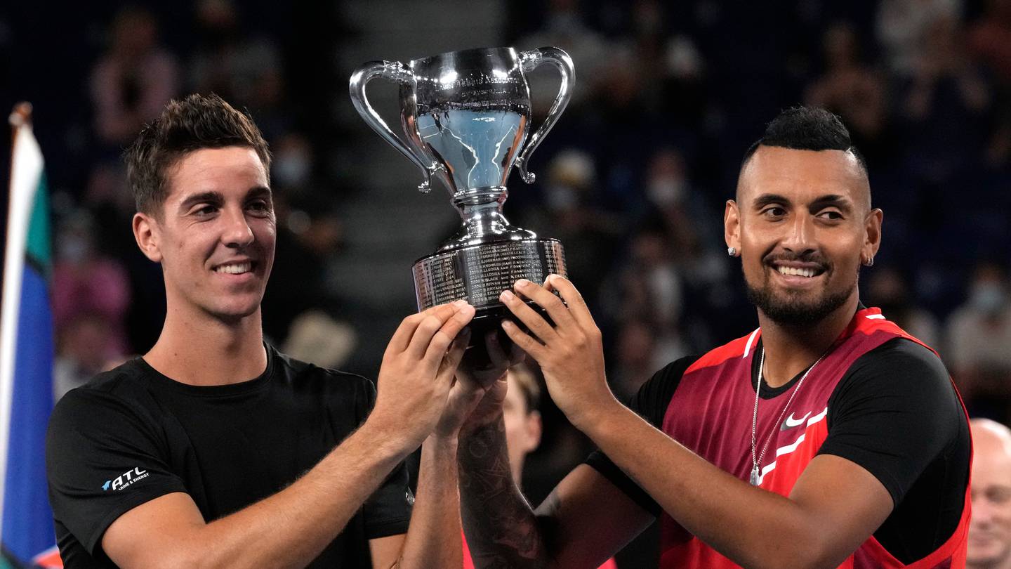 Nick Kyrgios, right, and Thanasi Kokkinakis, left, of Australia hold their trophy aloft after defeating compatriots Matthew Ebden and Max Purcell in the men's doubles final. Photo / AP