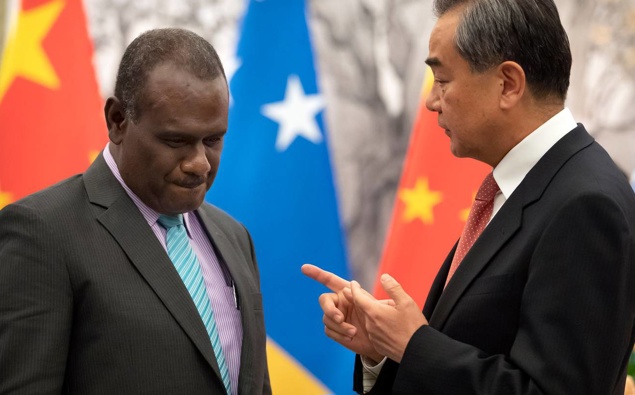 Solomon Islands Foreign Minister Jeremiah Manele, left, and Chinese Foreign Minister Wang Yi talk during a ceremony to mark the establishment of diplomatic relations. Photo / AP